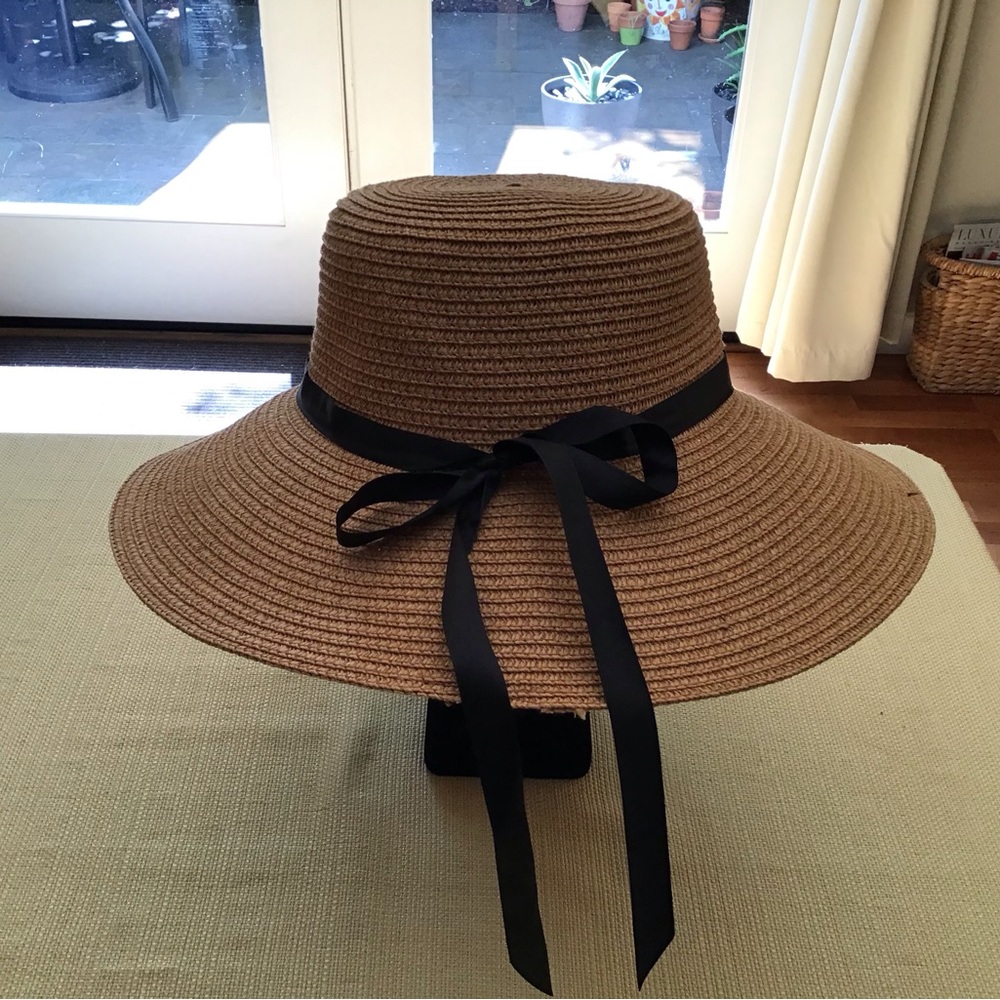 Summer straw hat. Tan with black ribbon trim. One size 4” brim, 15” W. L…
